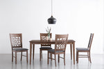 Modern wooden dining table with four chairs and a black pendant light