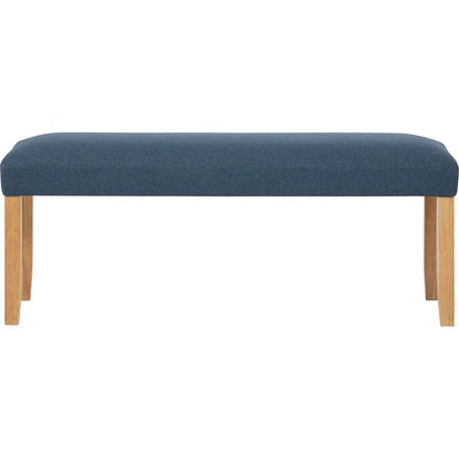 Modern upholstered bench with blue cushion and wooden legs on white background