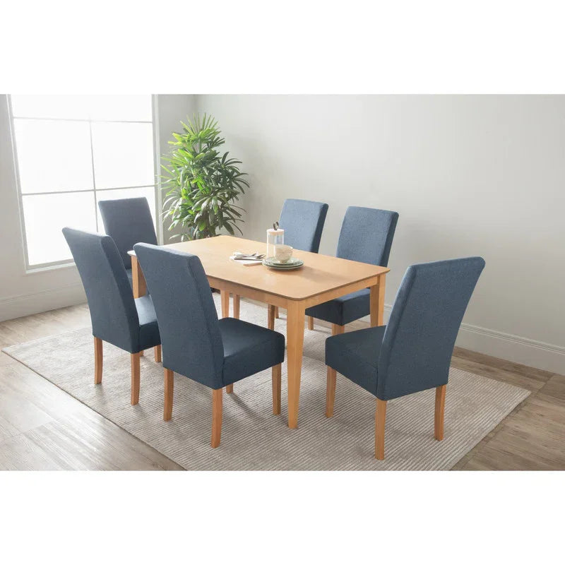 Modern dining room with wooden table, six blue upholstered chairs, plant, and large window