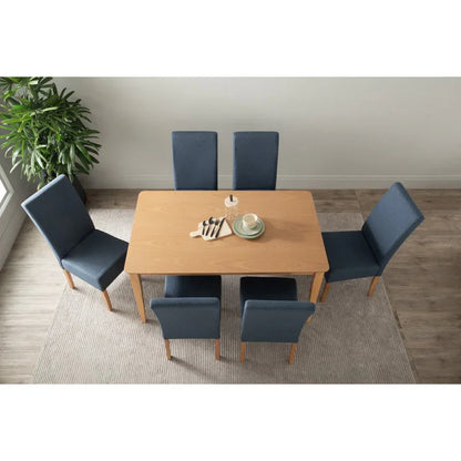 Modern dining room with light wood table, six blue chairs, dishes, and plant on rug