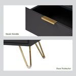 Black nightstand close-up with gold sleek handle and gold metal legs with floor protectors