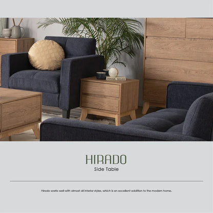 Modern living room with navy armchairs, wood Hirado side table, green plant, and decor accents