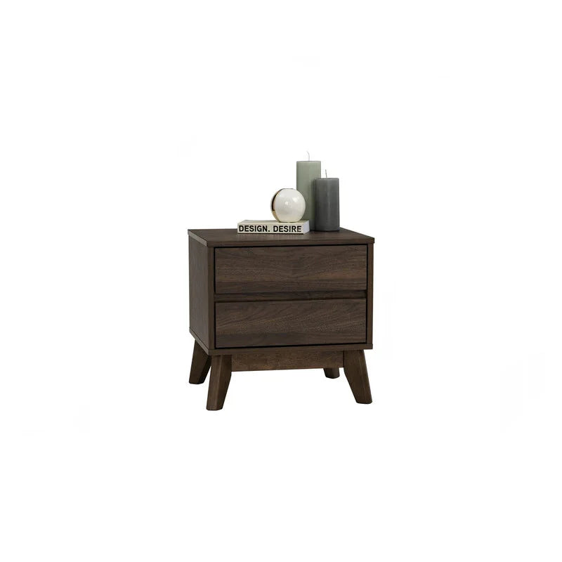 Mid-century modern dark wood nightstand with two drawers, candles, book, and decorative orb