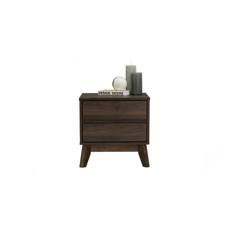 Mid-century modern dark wood nightstand with two drawers, candles, and decorative book on top