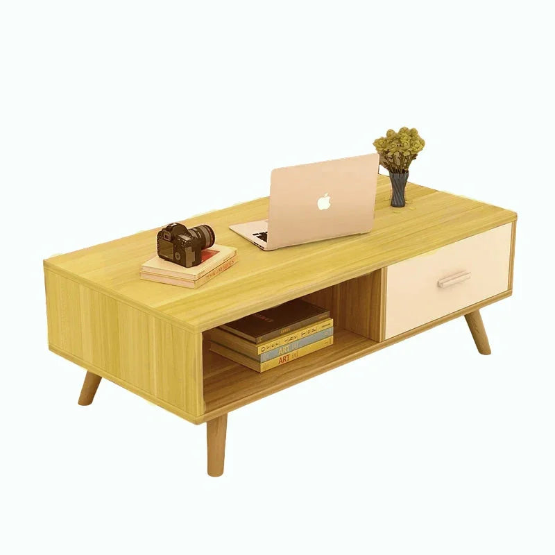 Modern wooden coffee table with laptop, camera, books and a vase on a white background