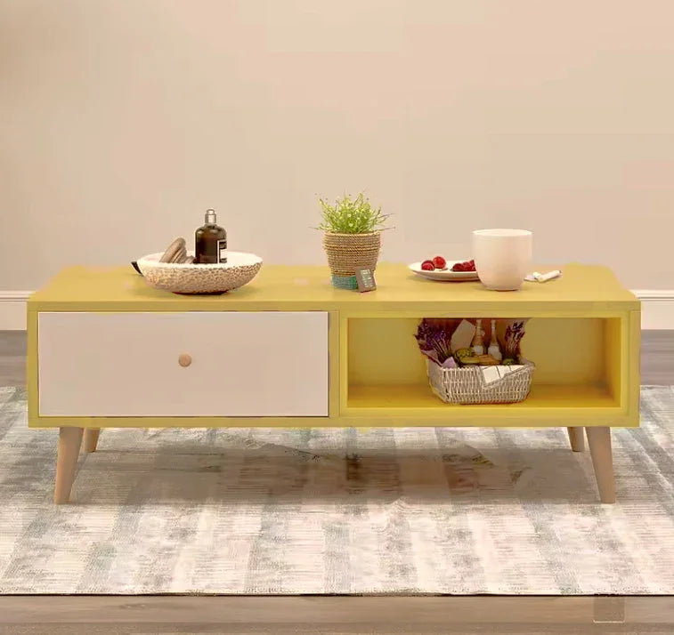 Modern yellow coffee table with white drawer, decor items, and basket on rug
