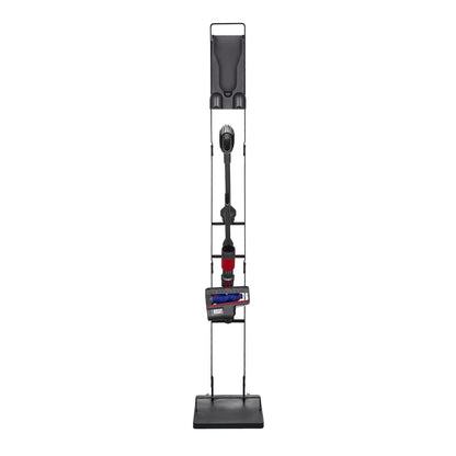 Cordless vacuum cleaner on a black stand, upright with attachment and red accents