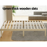Minimalist wooden bed frame with 13mm thick wooden slats in a modern living room
