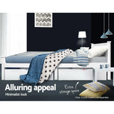 White minimalist bed with blue striped bedding, polka dot blanket, under-bed storage drawers