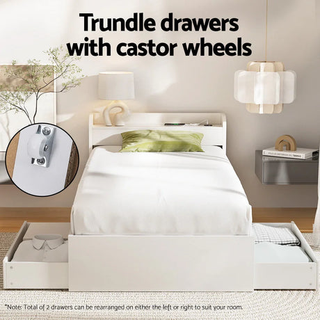 White modern single bed with green pillow and trundle drawers with castor wheels in bright bedroom