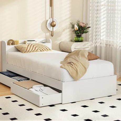 Modern white single bed with storage drawers, beige bedding, and decorative wall light in cozy bedroom