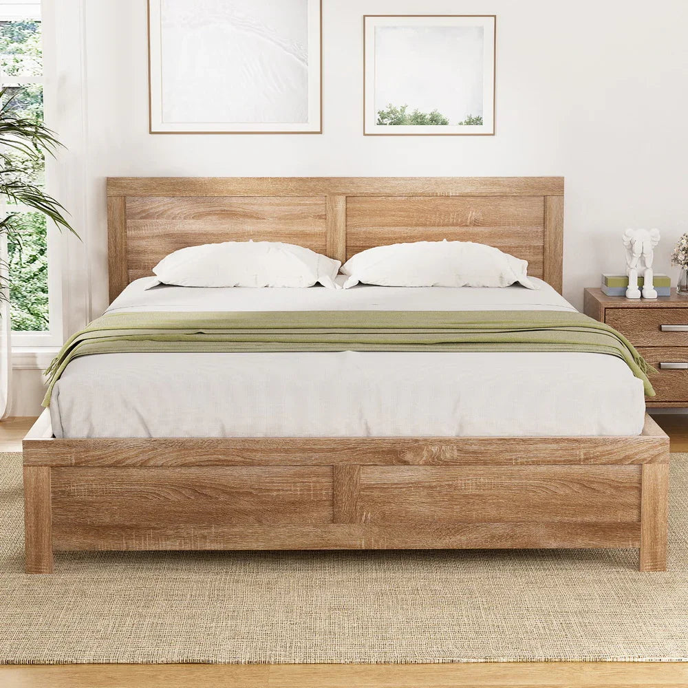 Oatmeal wooden bed frame with white bedding and green throw in bright modern bedroom