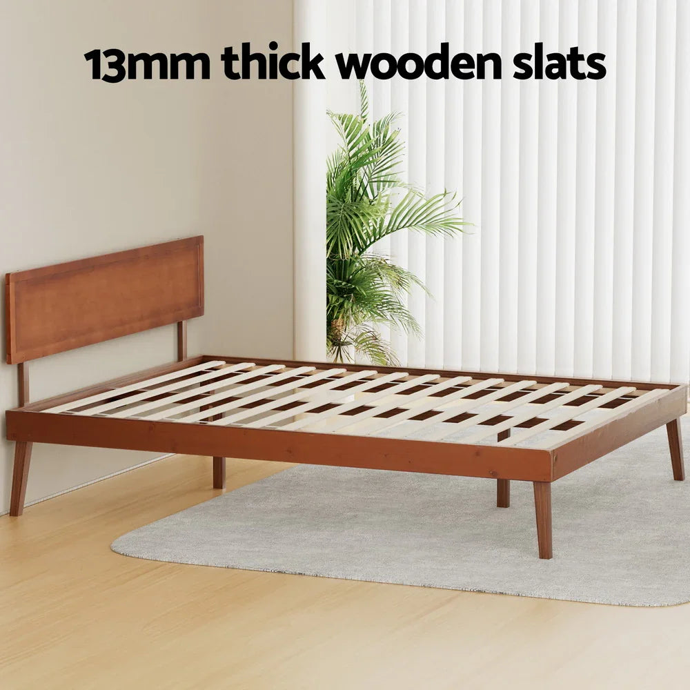 Wooden bed frame with 13mm thick slats, mid-century modern style, in bright room with plant